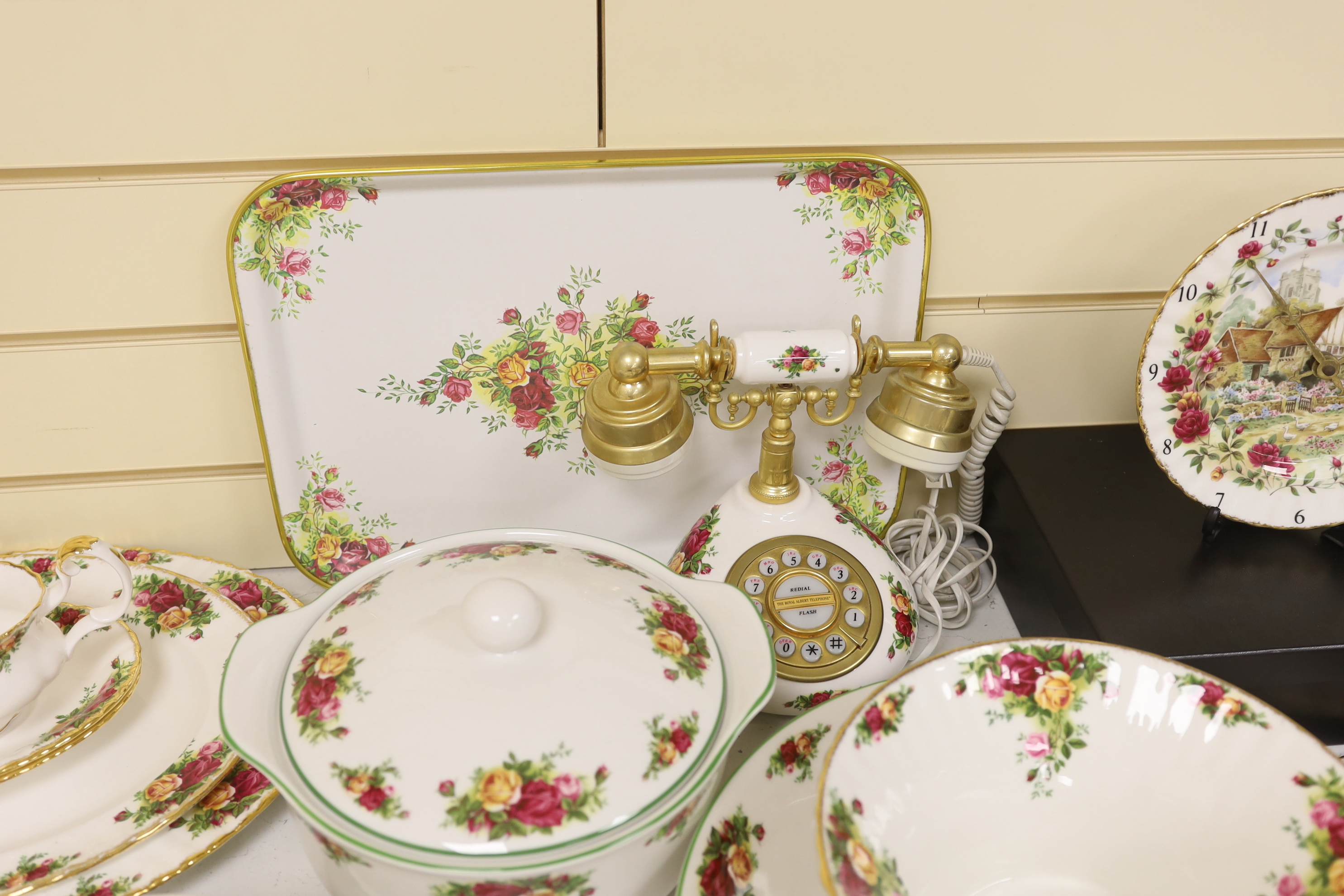 Royal Albert Old Country Roses, a large bone china service for twelve-place setting, and related accessories telephone, wall clock, table mats, napkins and cutlery.